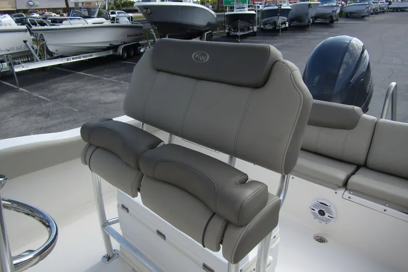 Slide: The Image of 2022 Key West 219 FS boat interior with cushioned seating and steering wheel. - 16