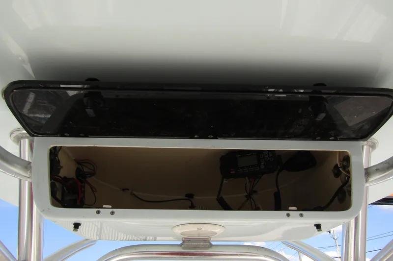 Slide: The Image of 2022 Key West 219 FS boat console storage with electronic equipment and wiring. - 18