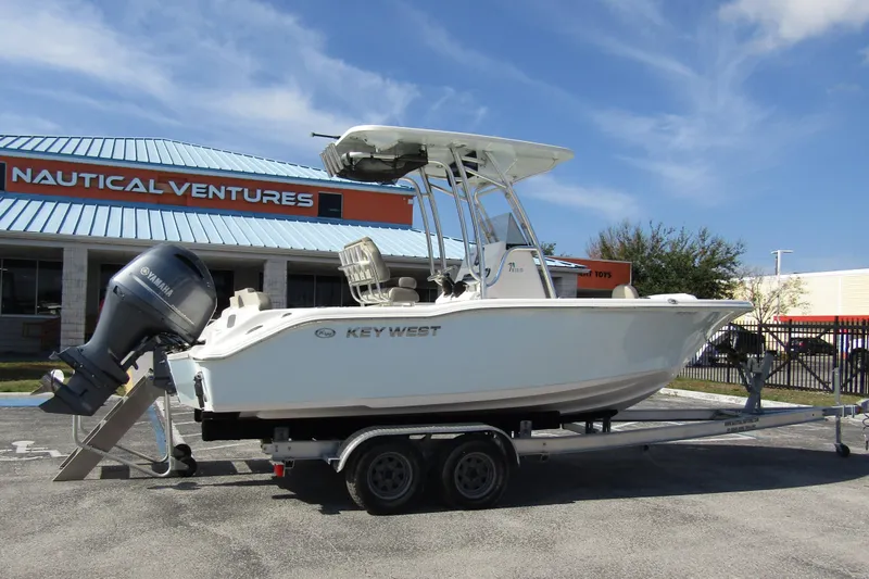 Slide: The Image of 2022 Key West 219 FS boat on trailer outside Nautical Ventures store. - 2