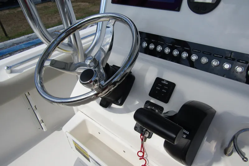 Slide: The Image of 2022 Key West 219 FS boat helm with steering wheel and control panel. - 26