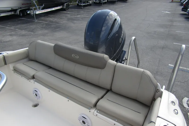 Slide: The Image of 2022 Key West 219 FS boat with cushioned seating and Yamaha outboard motor. - 29