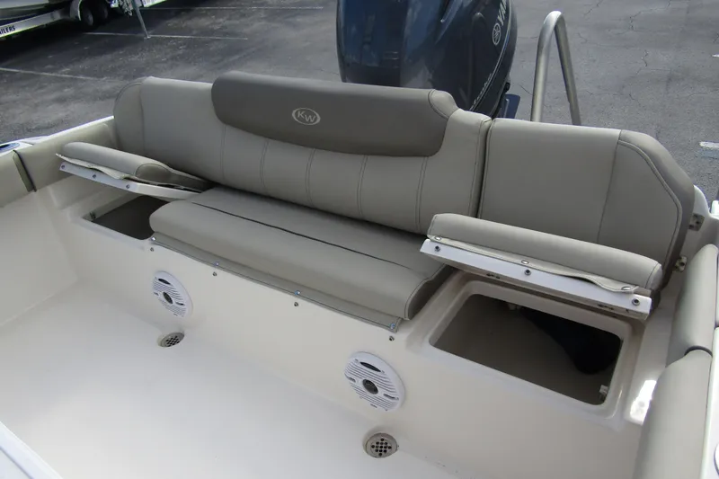 Slide: The Image of 2022 Key West 219 FS boat interior with cushioned seating and storage compartments. - 30