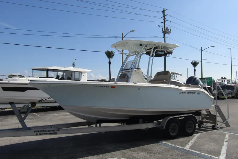 Slide: The Image of 2022 Key West 219 FS boat on trailer in parking lot. - 5