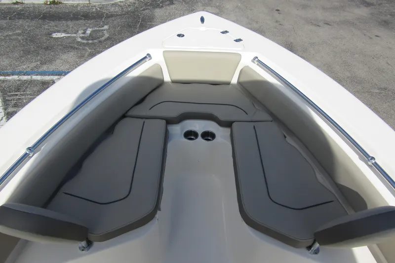 Slide: The Image of 2022 Key West 219 FS boat interior with cushioned seating and cup holders. - 9