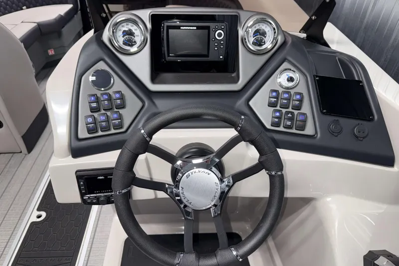 Slide: The Image of 2026 Sylvan L3 SLZ Platinum boat dashboard with steering wheel and control panel. - 12