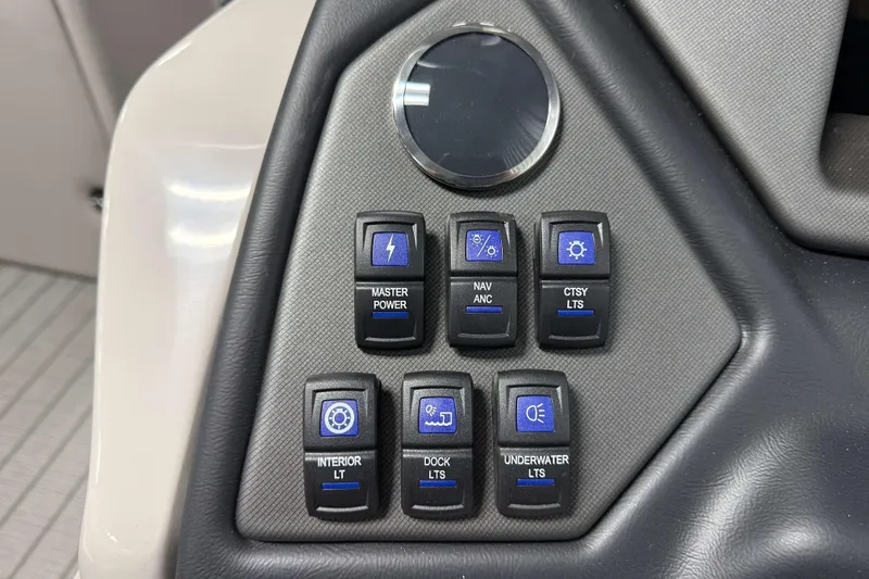 Slide: The Image of Control panel of 2026 Sylvan L3 SLZ Platinum boat with various lighting switches. - 13