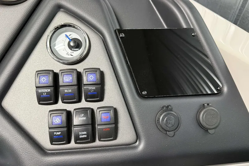 Slide: The Image of Control panel of 2026 Sylvan L3 SLZ Platinum boat with switches and trim gauge. - 15