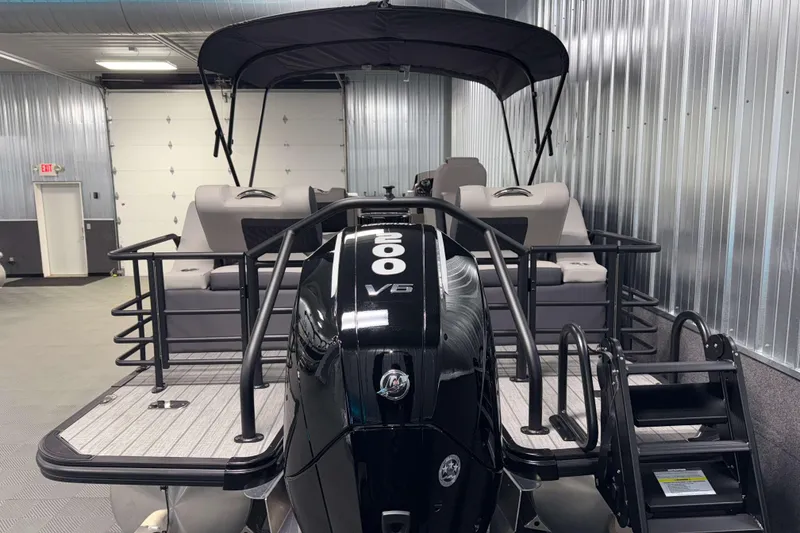 Slide: The Image of 2026 Sylvan L3 SLZ Platinum pontoon boat with V6 engine in a garage. - 36