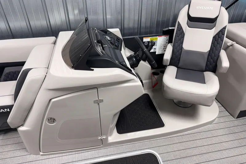 Slide: The Image of 2026 Sylvan L3 SLZ Platinum boat interior with captain's chair and control panel. - 8