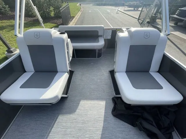 Slide: The Image of 2024 Godfrey Pontoons Mighty G 1476 F interior with gray seating and open deck layout. - 4