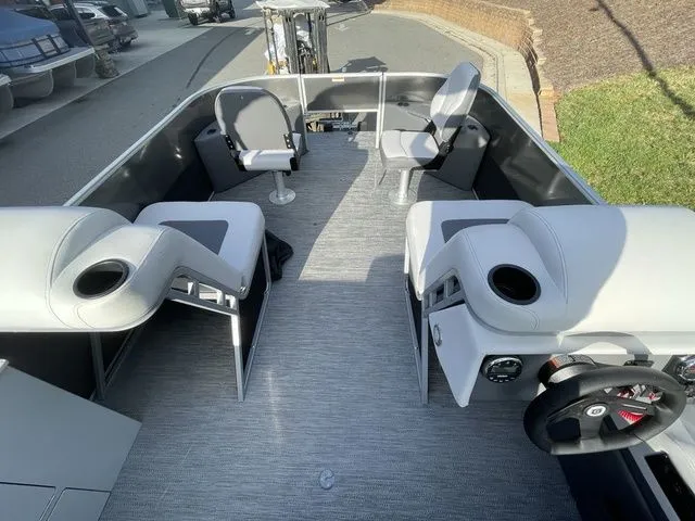 Slide: The Image of 2024 Godfrey Pontoons Mighty G 1476 F interior with seating and steering wheel. - 7