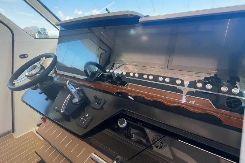 Slide: The Image of 2024 Tiara Yachts 48 LS helm with modern controls and navigation displays. - 24