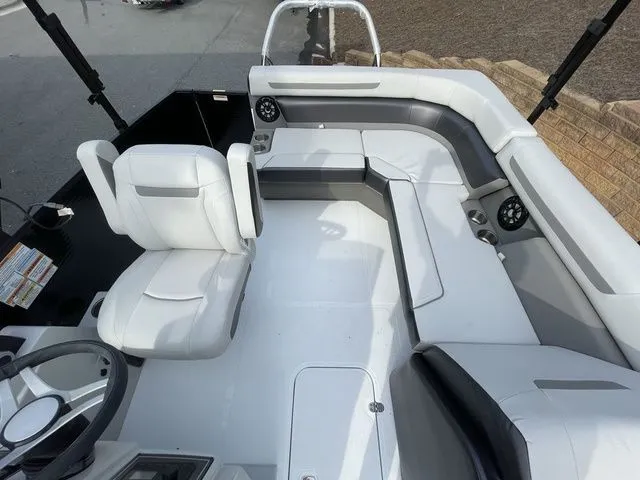 Slide: The Image of 2024 Hurricane FunDeck 1960 RE OB interior with white seating and modern design. - 11