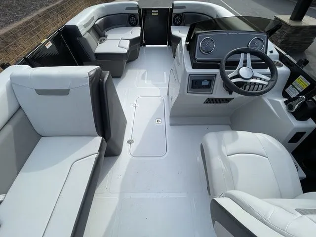 Slide: The Image of 2024 Hurricane FunDeck 1960 RE OB boat interior with spacious seating and modern dashboard. - 5