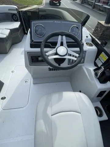 Slide: The Image of 2024 Hurricane FunDeck 1960 RE OB boat dashboard with steering wheel and seating. - 6