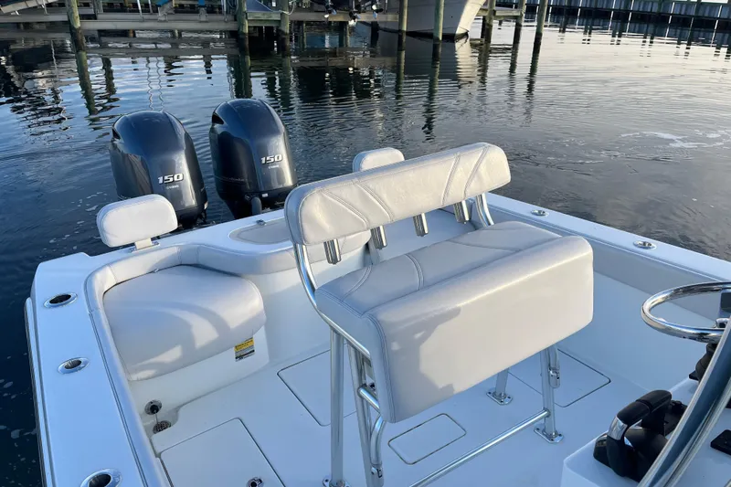 Slide: The Image of 2023 Contender 24 Sport boat with dual 150 engines, white seating, and sleek design. - 18