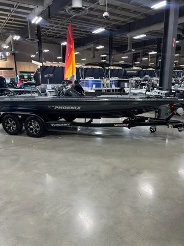 Slide: The Image of 2024 Phoenix Bass Boats 919 Elite on display in a showroom with sleek design. - 3