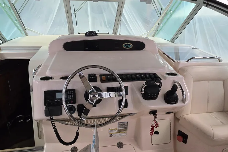 Slide: The Image of Helm of 2014 Grady-White Express 370 boat with steering wheel and controls. - 11