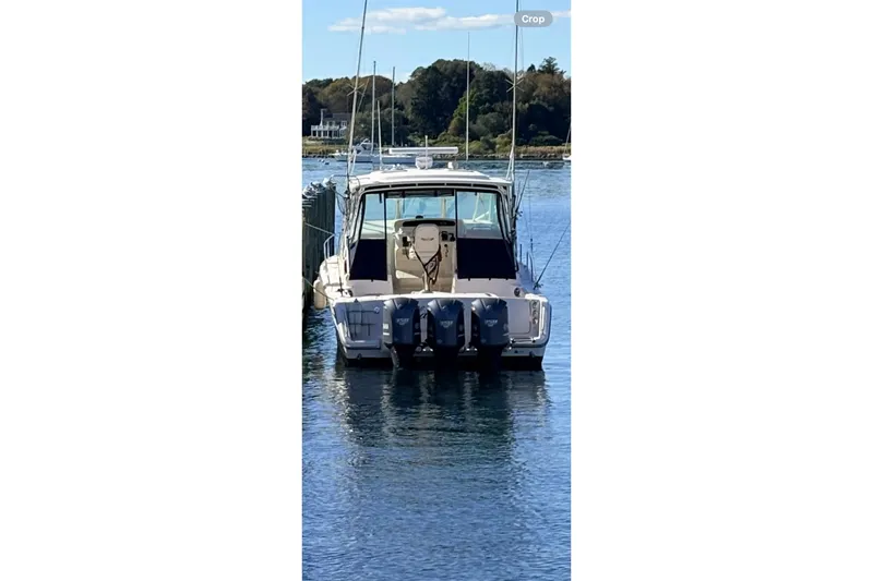 Slide: The Image of 2014 Grady-White Express 370 boat docked on calm water, rear view. - 13