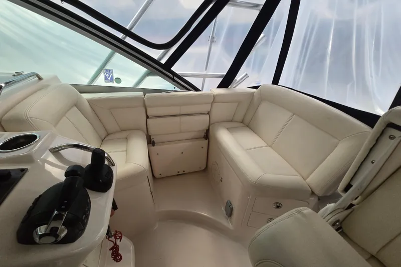 Slide: The Image of 2014 Grady-White Express 370 boat interior with beige seating and control panel. - 8