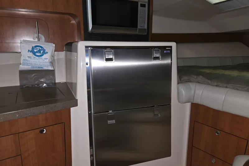 Slide: The Image of 2014 Grady-White Express 370 interior with stainless steel fridge and microwave. - 9