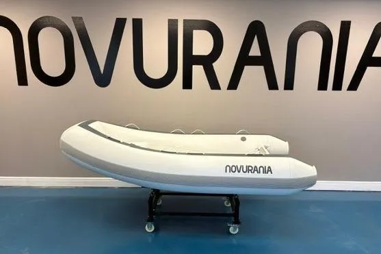 The Image of 2025 Novurania TR 270 inflatable boat displayed indoors with contact information and decorative plants. - 0