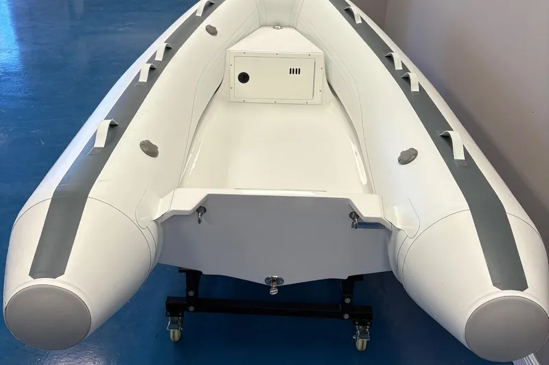 Slide: The Image of 2025 Novurania TR 270 inflatable boat displayed indoors with contact information. - 2