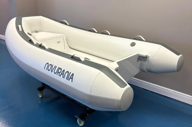 Slide: The Image of 2025 Novurania TR 270 inflatable boat displayed indoors with accessories. - 3