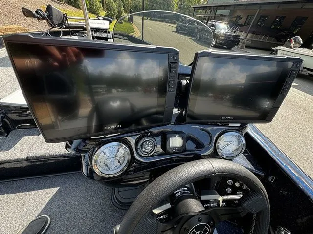 Slide: The Image of 2024 Phoenix Bass Boats 20 XE dashboard with dual Garmin displays and steering wheel. - 8
