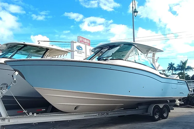 The Image of 2026 Grady-White Freedom 325 boat on trailer under blue sky. - 1