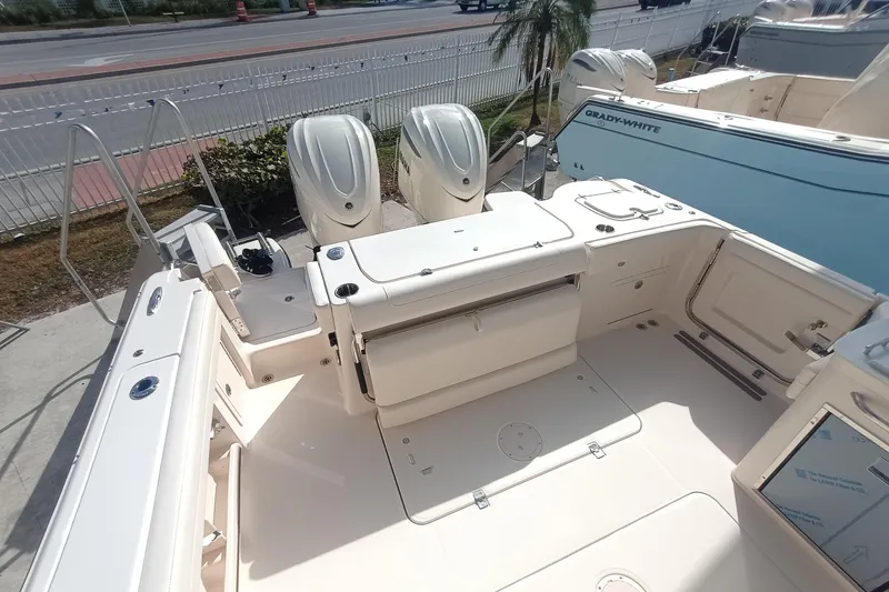 Slide: The Image of 2026 Grady-White Freedom 325 boat interior with triple outboard engines. - 13