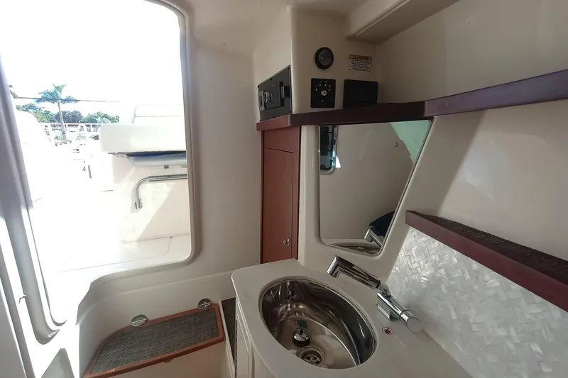 Slide: The Image of 2026 Grady-White Freedom 325 boat interior with sink and mirror. - 26