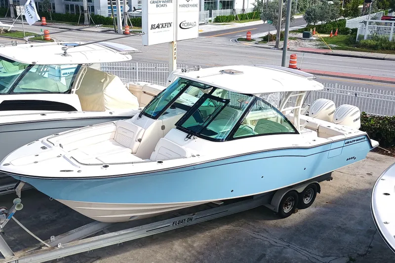 Slide: The Image of 2026 Grady-White Freedom 325 boat on trailer, displayed outdoors. - 3