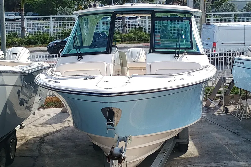 Slide: The Image of 2026 Grady-White Freedom 325 boat displayed outdoors on a trailer. - 4