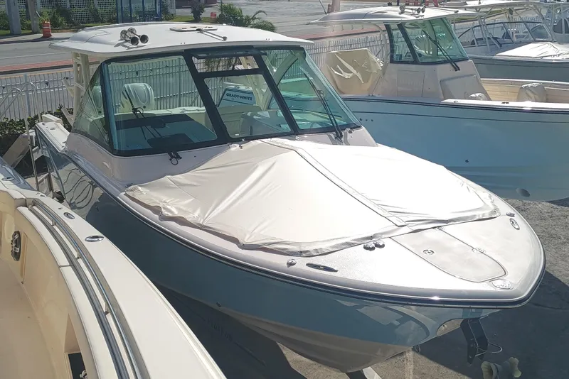 Slide: The Image of 2026 Grady-White Freedom 325 boat displayed in a marina under sunlight. - 9