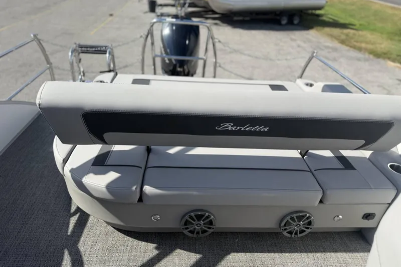 Slide: The Image of 2026 Barletta ARIA 22UC boat interior with cushioned seating and speaker system. - 21