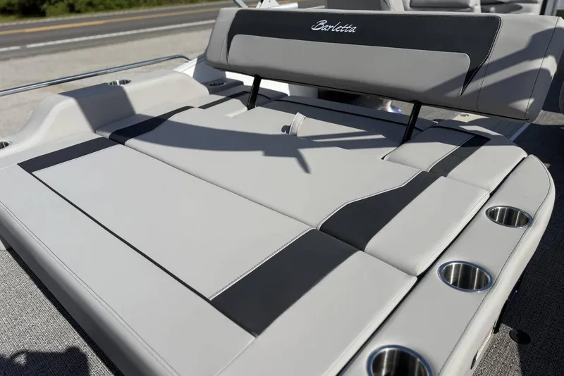 Slide: The Image of 2026 Barletta ARIA 22UC boat with sleek gray seating and integrated cup holders. - 22