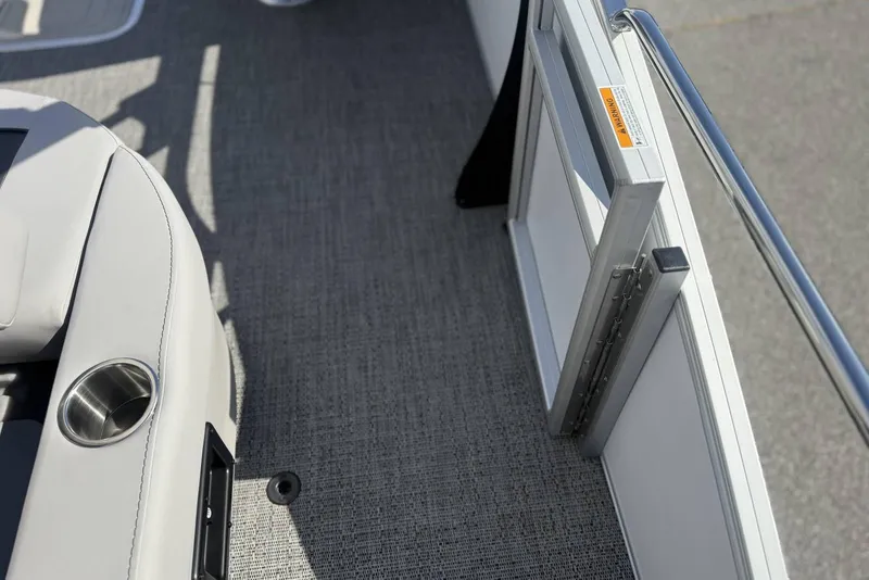 Slide: The Image of Interior view of 2026 Barletta ARIA 22UC boat, featuring seating and a safety gate. - 29