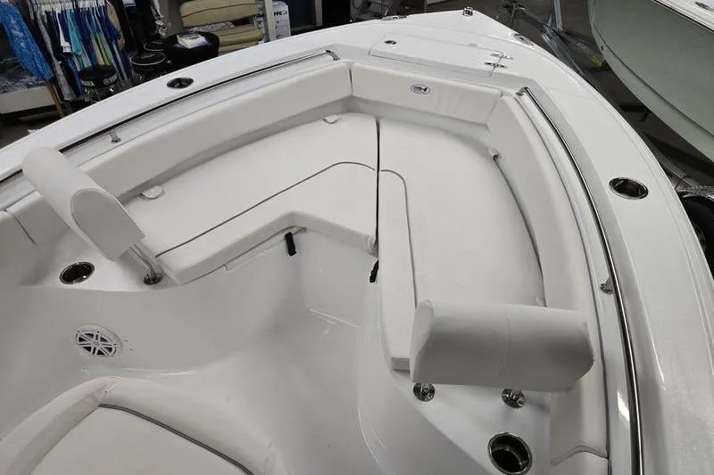 Slide: The Image of 2026 Sea Hunt Ultra 219 boat interior with white cushioned seating and stainless steel fixtures. - 11