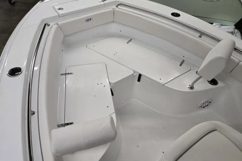 Slide: The Image of 2026 Sea Hunt Ultra 219 boat interior with white seating and storage compartments. - 12