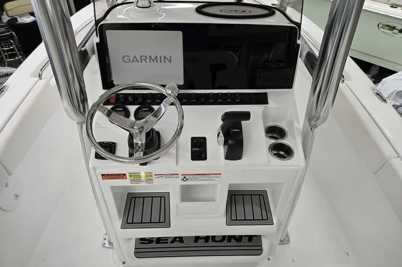 Slide: The Image of 2026 Sea Hunt Ultra 219 boat console with Garmin navigation system and steering wheel. - 16