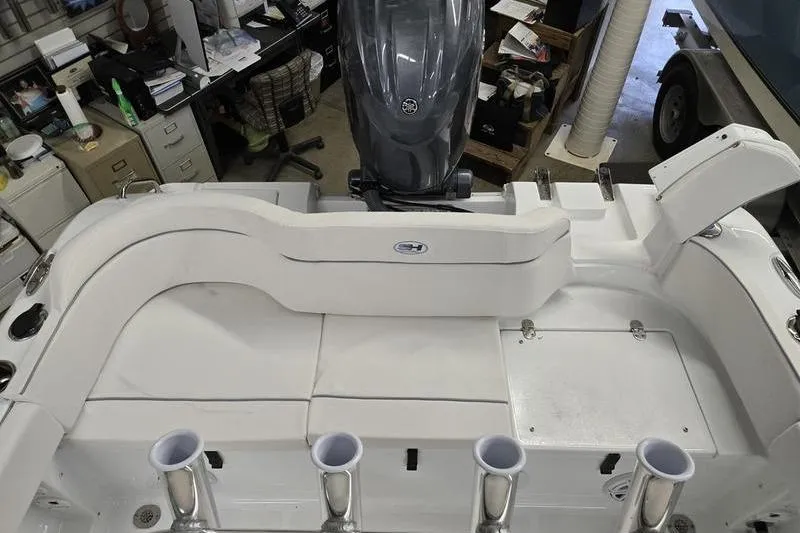 Slide: The Image of 2026 Sea Hunt Ultra 219 boat interior with motor and seating arrangement. - 21