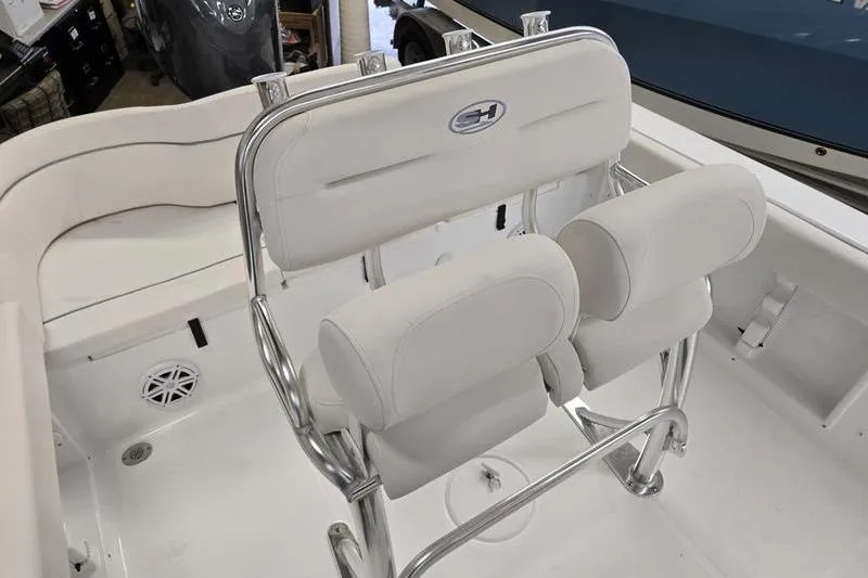 Slide: The Image of 2026 Sea Hunt Ultra 219 boat interior with white cushioned seating and stainless steel frame. - 22