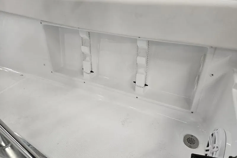 Slide: The Image of Interior view of 2026 Sea Hunt Ultra 219 boat, featuring white deck and drainage system. - 23