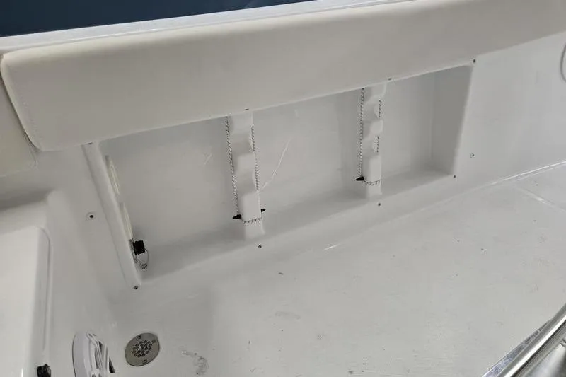 Slide: The Image of Interior view of 2026 Sea Hunt Ultra 219 boat, featuring white seating and storage area. - 6