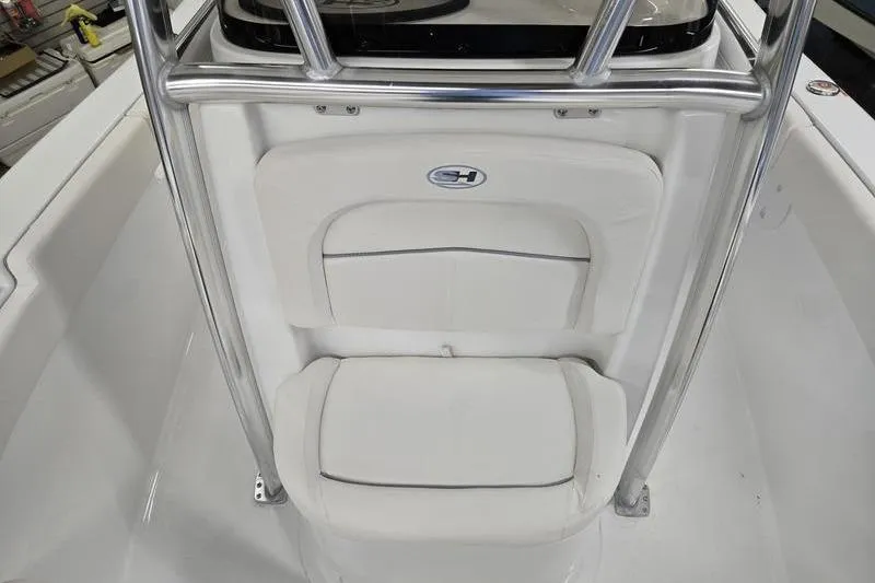 Slide: The Image of 2026 Sea Hunt Ultra 219 boat interior with white cushioned seating and metal railing. - 7