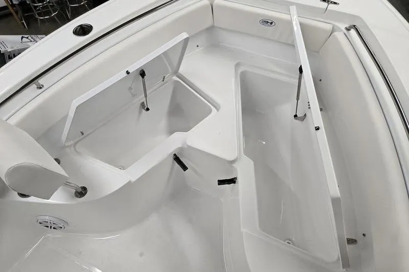 Slide: The Image of 2026 Sea Hunt Ultra 219 boat interior with open storage compartments. - 8