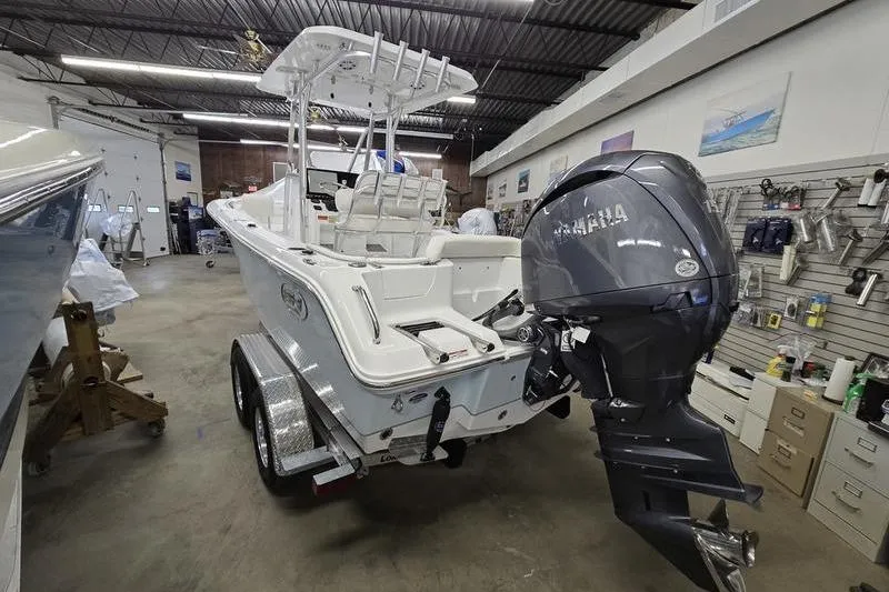 Slide: The Image of 2026 Sea Hunt Ultra 219 boat with Yamaha engine in a showroom. - 9