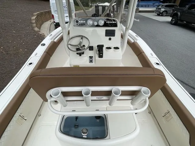 Slide: The Image of 2024 Pioneer Sportfish 202 boat console with steering wheel and rod holders. - 5