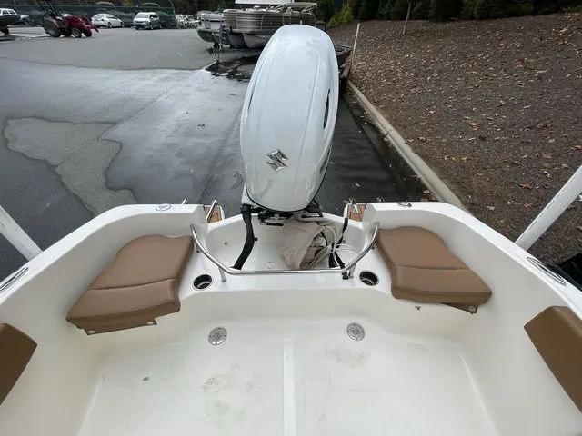 Slide: The Image of 2024 Pioneer Sportfish 202 boat with Suzuki outboard motor, featuring tan seating and spacious deck. - 12